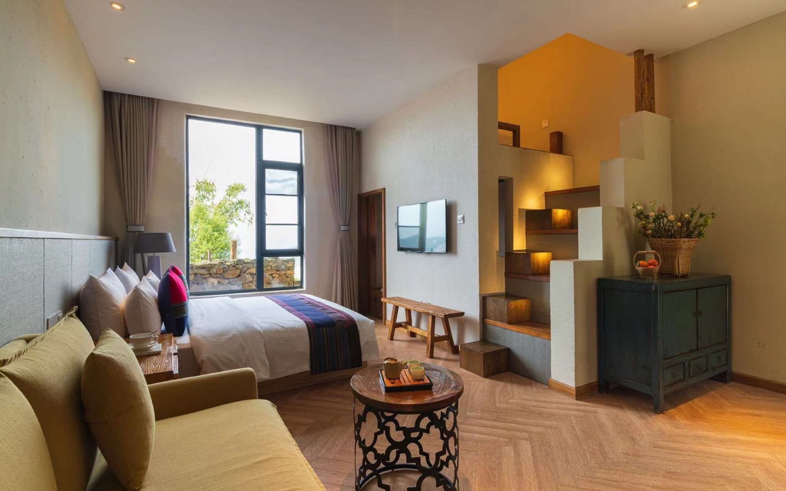 Family room with multiple beds and a separate sitting area