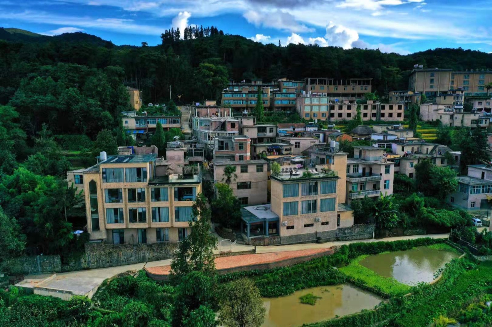 The manor and village buildings set within the Yuanyang rice terrace landscape